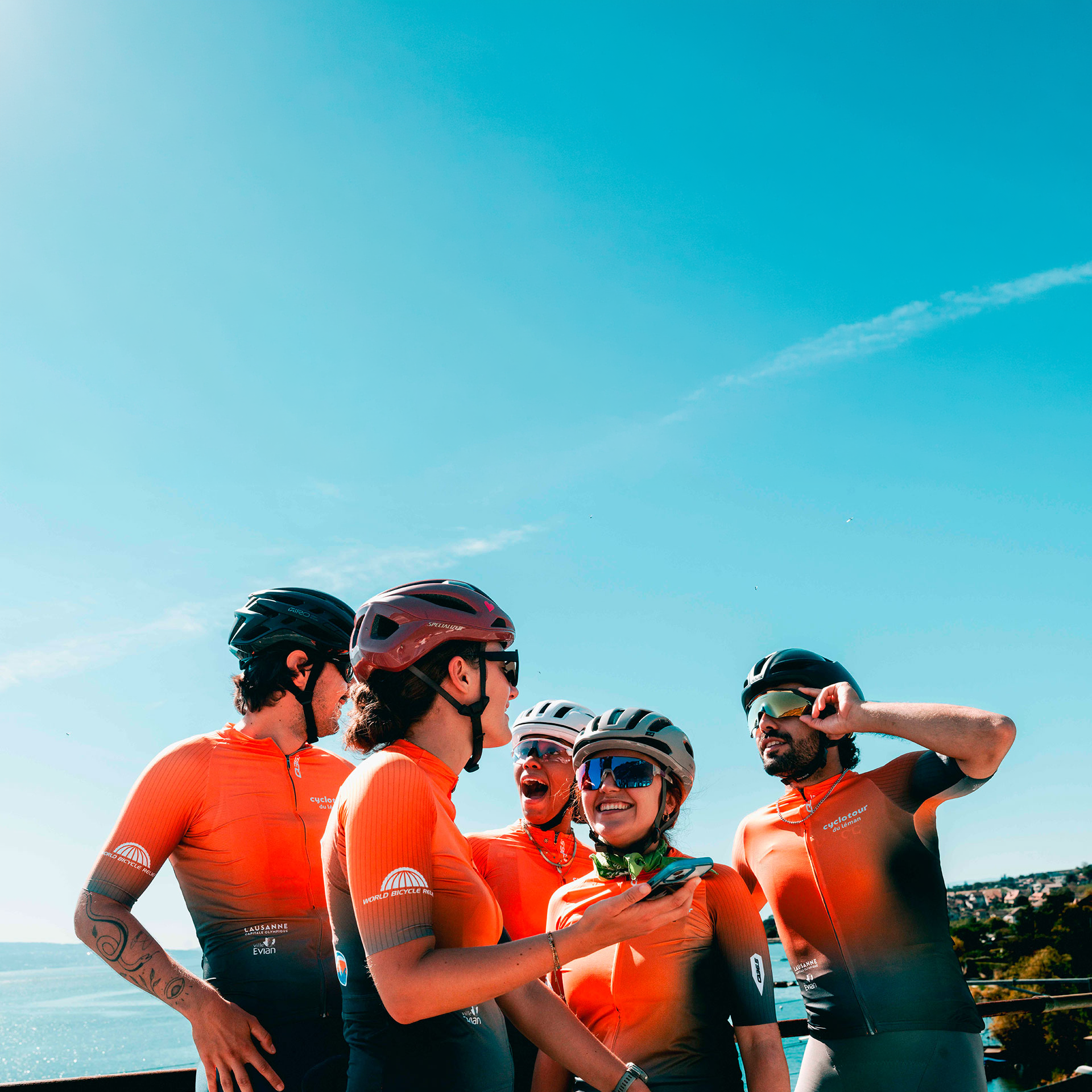 Group of cyclists laughing together, matching outfit