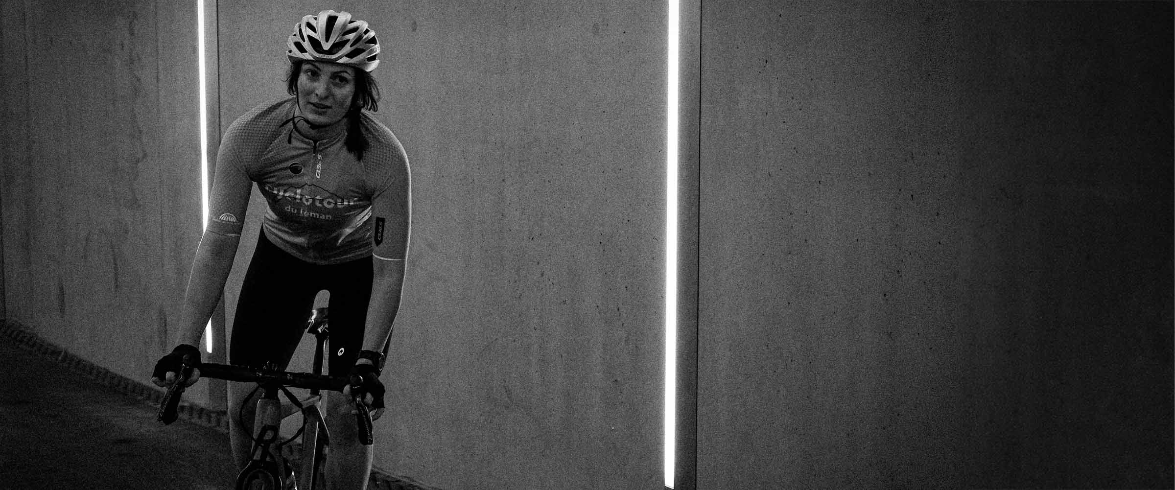 Female cyclist riding through tunnel