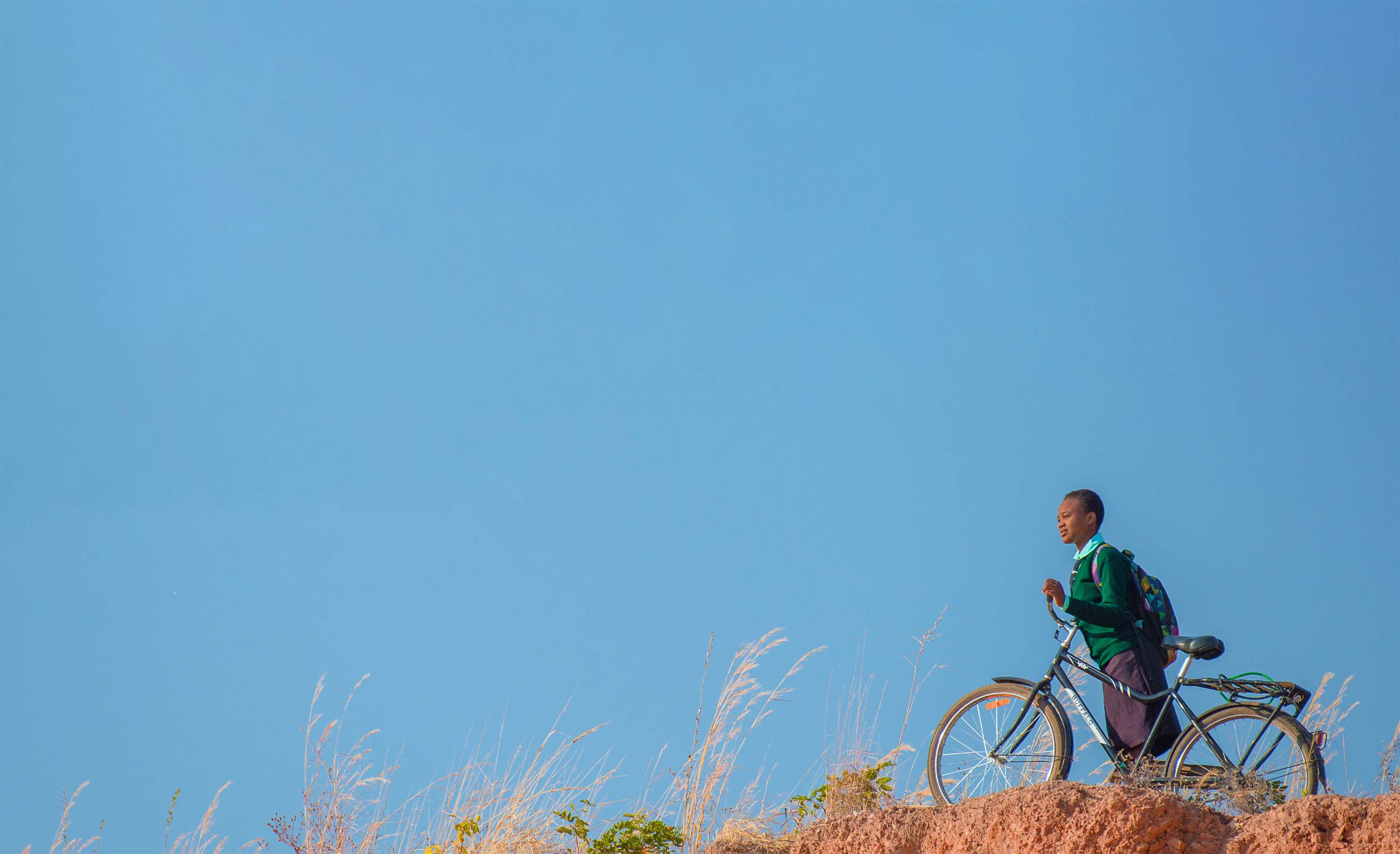 girl with bicycle on ridge in south africa